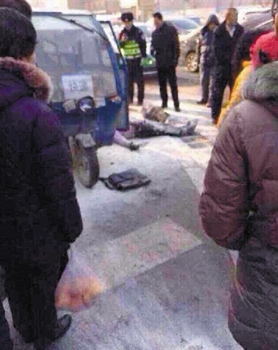 自焚車主躺在地上，身上被白色滅火器粉末覆蓋，一旁的三輪車上還標(biāo)有“快遞”兩字。